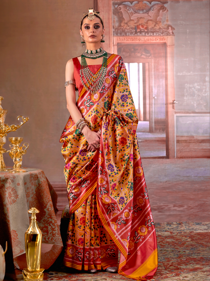 Woman in a colorful saree standing in an ornate room with a table and decorative items.