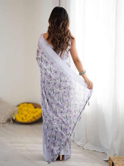 Woman in a white saree with floral patterns