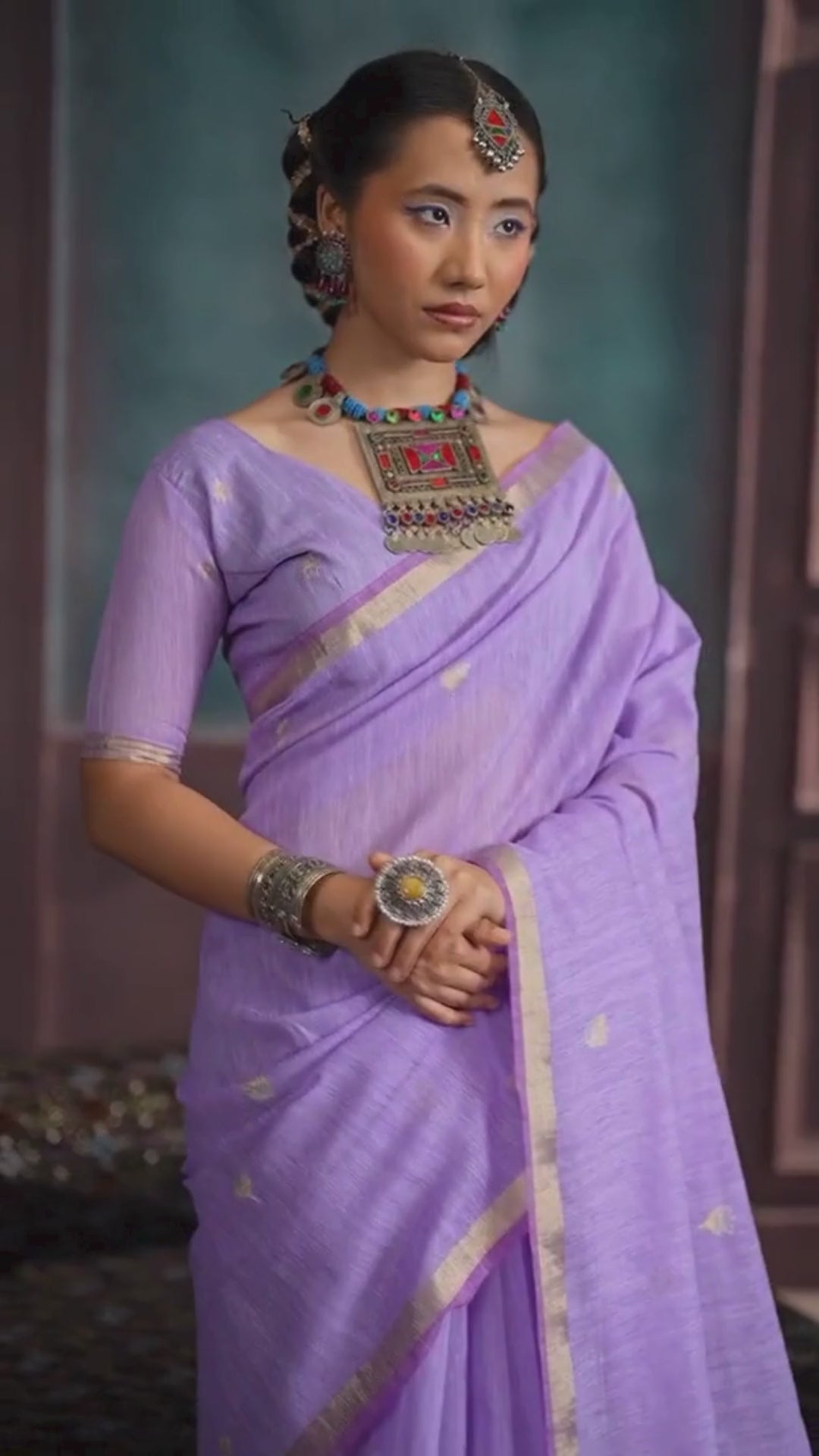 woman in lavender shade saree with jewellery